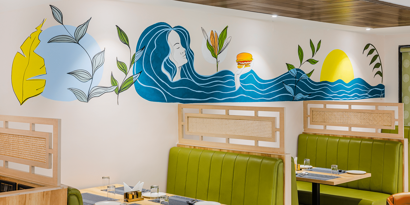 Lemonridge Hotels, KPHB | Close-up of artistic wall decorations in the dining area. Whimsical and colorful designs.